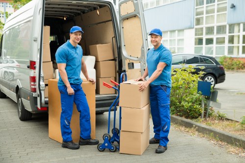 Professional mover securing furniture in a truck